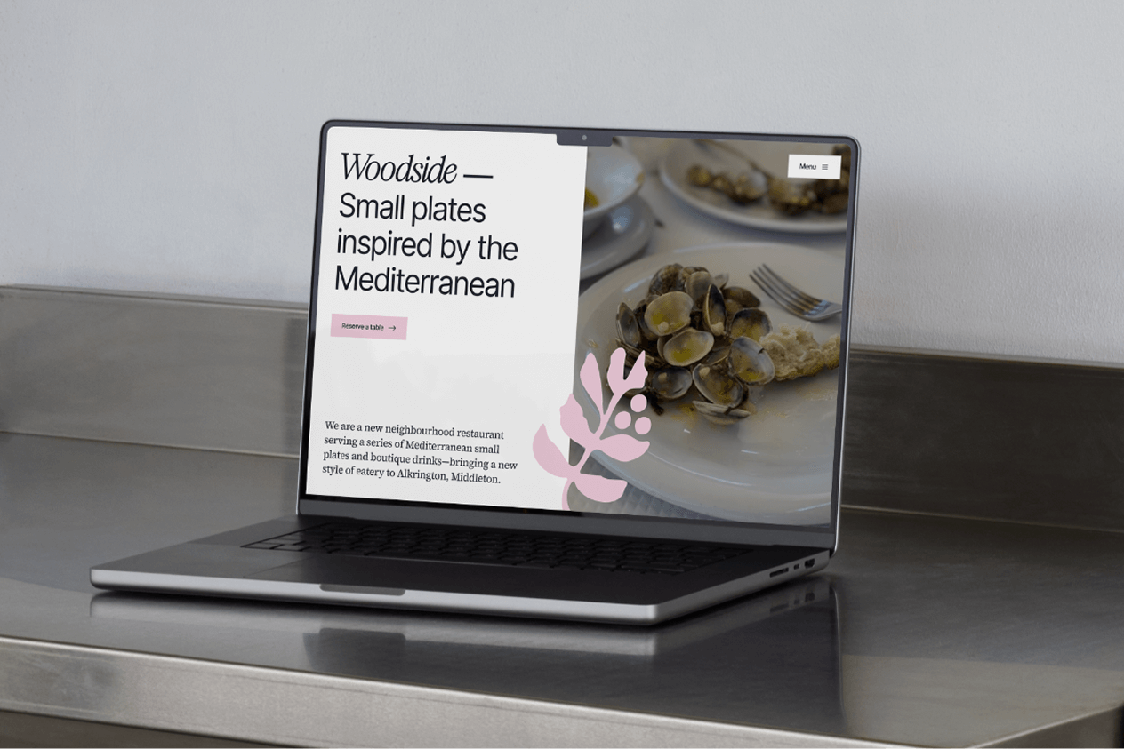 Hand holding phone that shows the homepage of savage bean coffee co