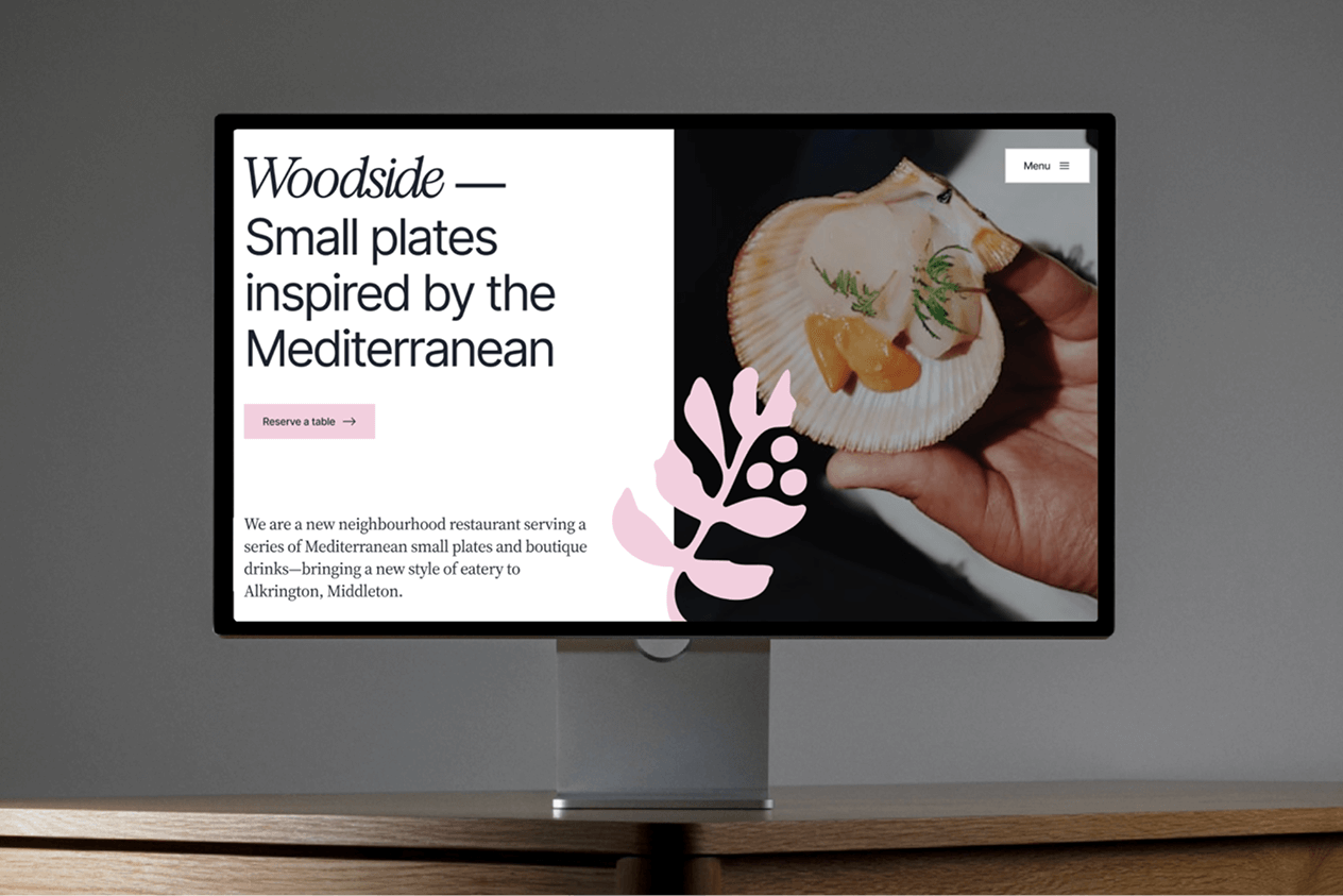 Hand holding phone that shows the homepage of savage bean coffee co