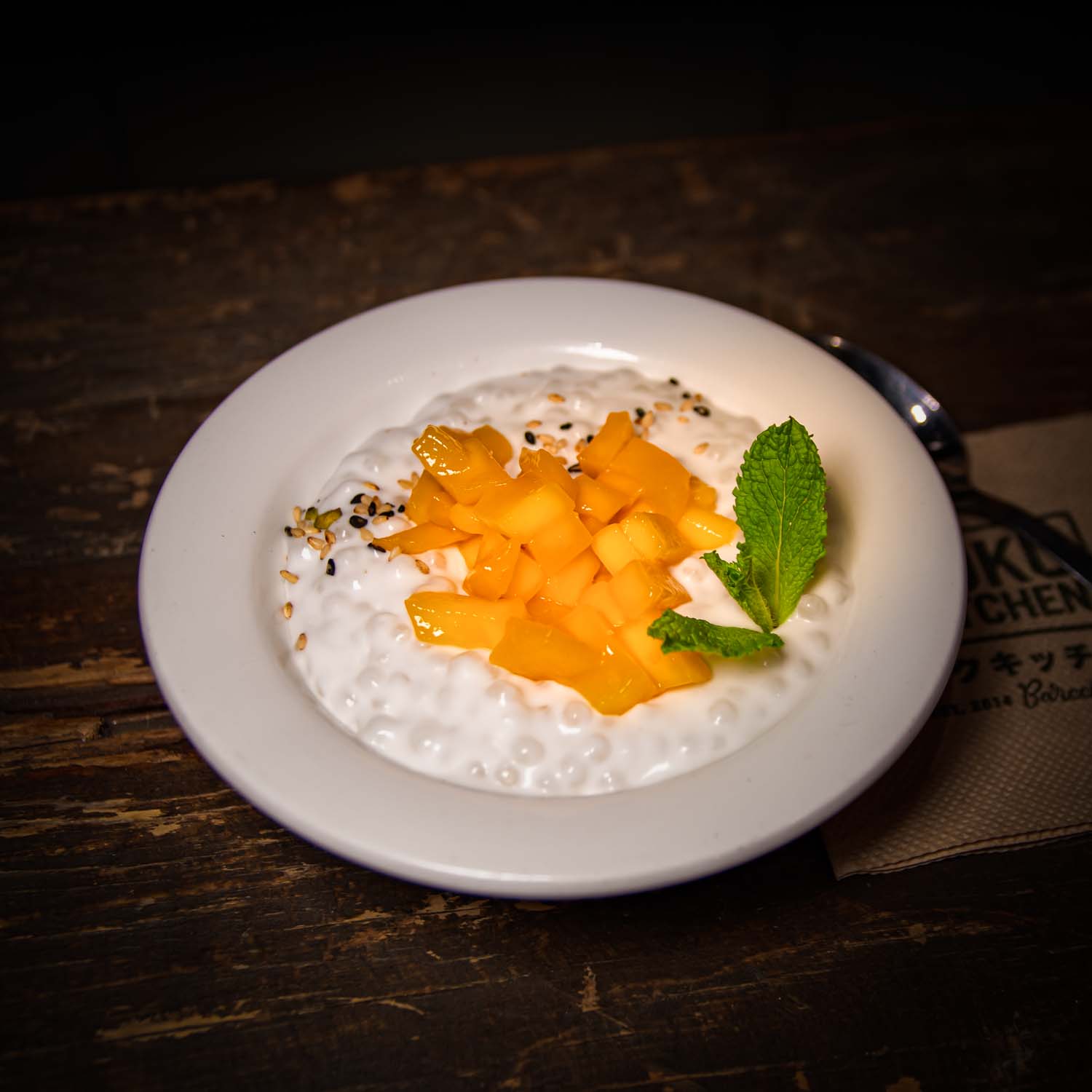 Coconut tapioca pudding with lemongrass infusion topped with fresh mango, a vegan dessert option
