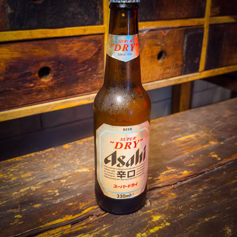 Bottle of Asahi Super Dry Lager, a crisp Japanese beer that pairs perfectly with Asian cuisine