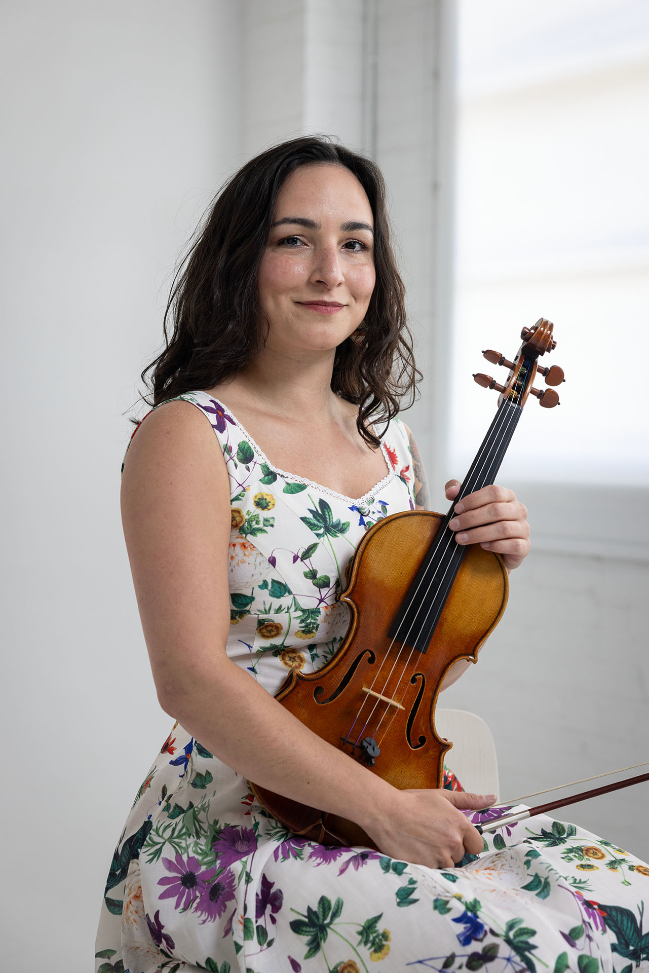 A portrait of violinist Nina Fronjian.