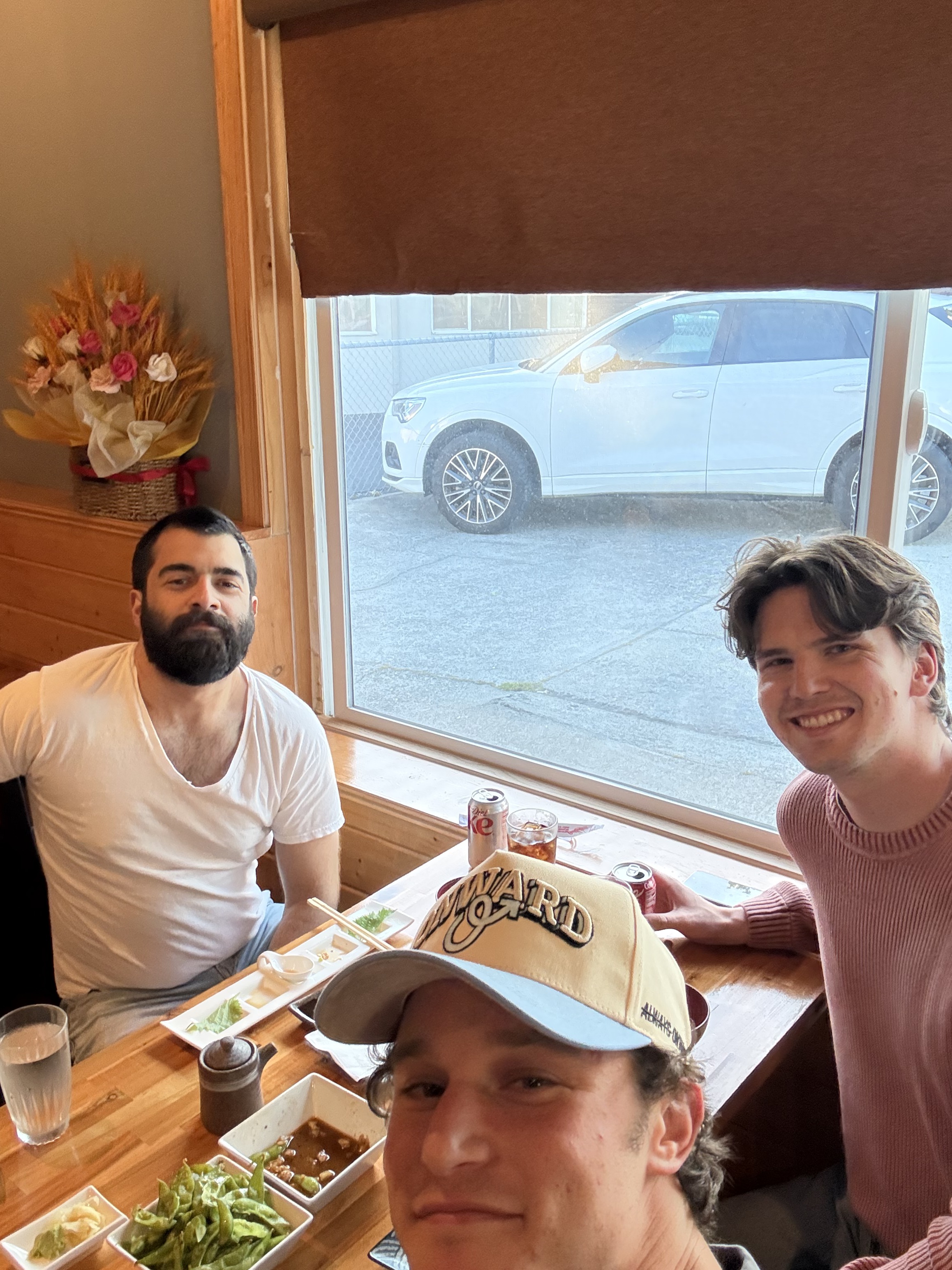 Three members of the Onward team sharing lunch at a restaurant table