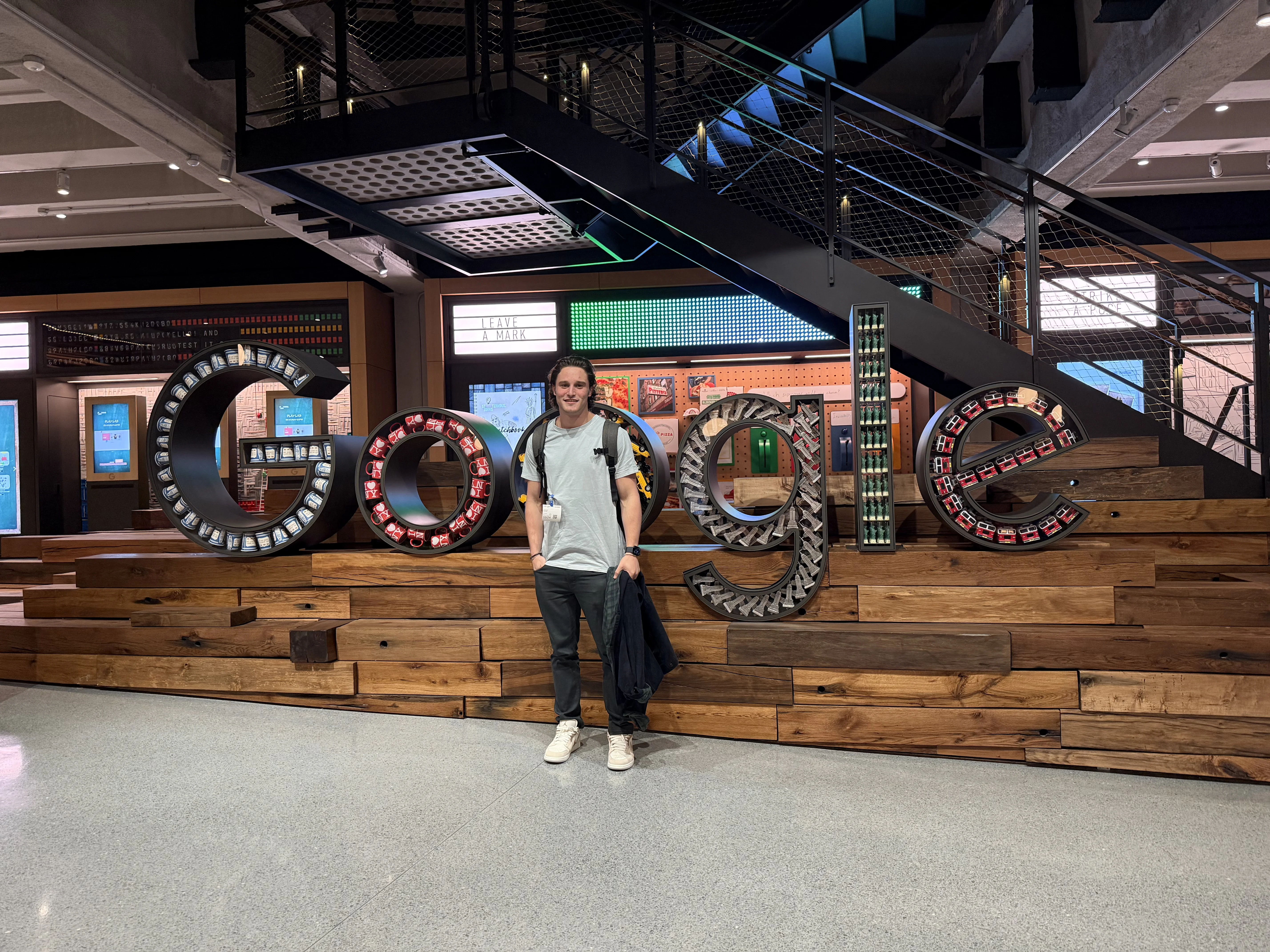 An Onward team member standing in front of the Google logo sculpture