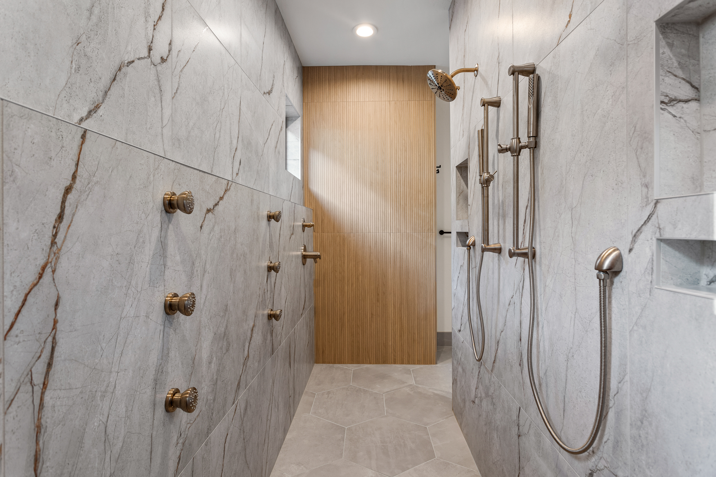image of inside a shower with knobs and marble