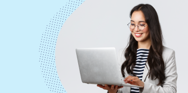 Woman smiling while using a laptop
