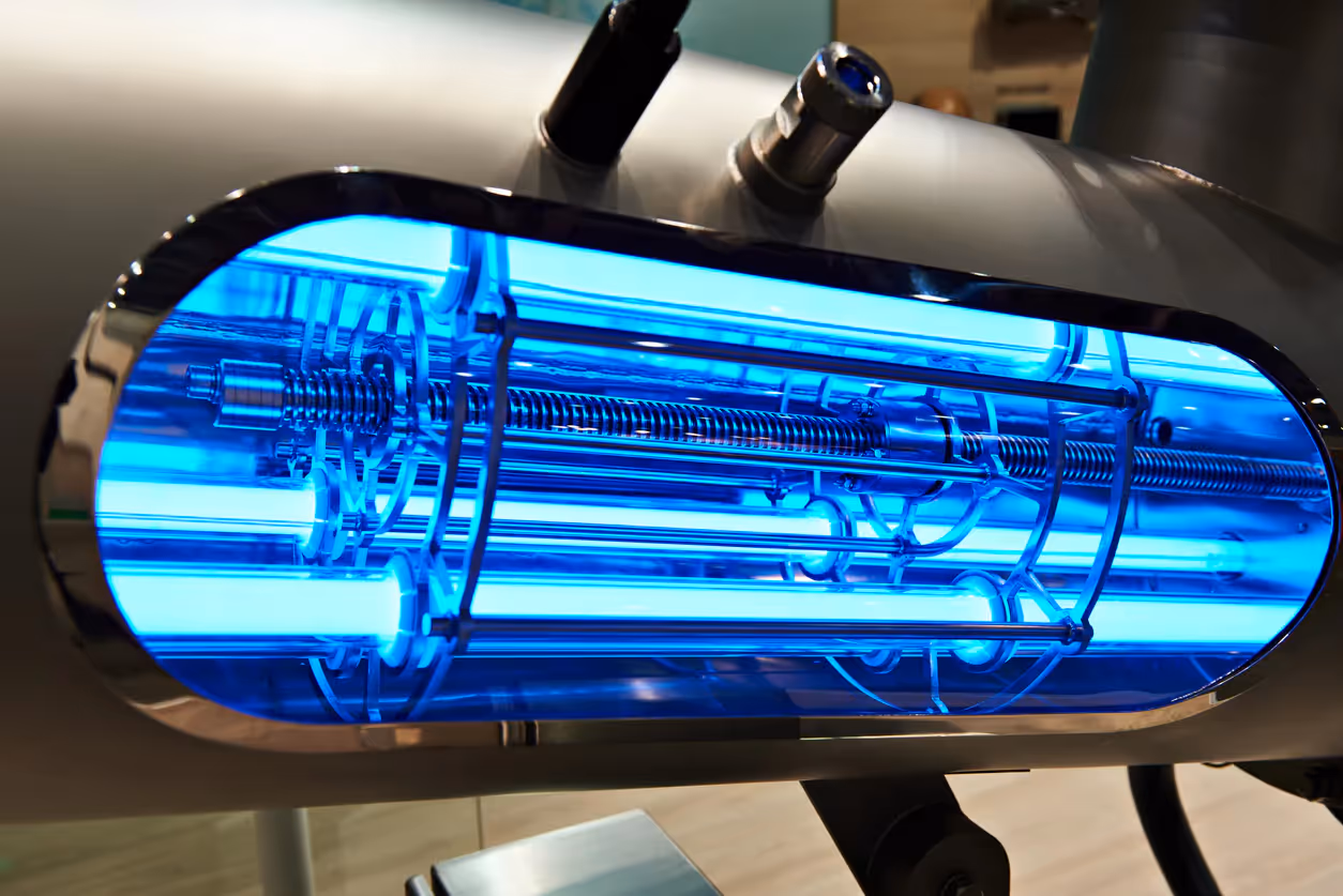 An open air duct with a glowing UV light air purifier inside