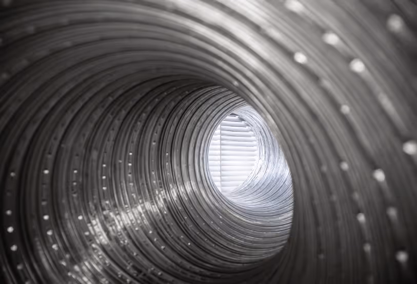 A deep view into a dirty, lint-filled dryer vent duct