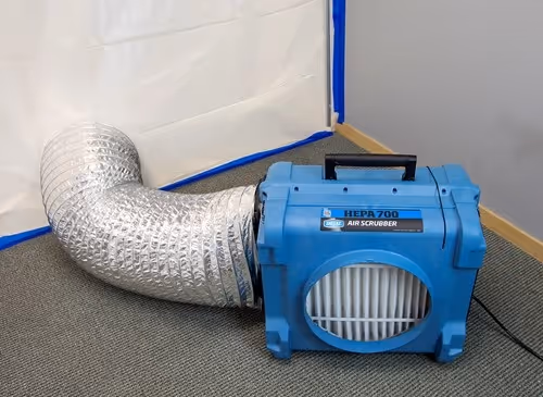 A portable air scrubber with a duct.