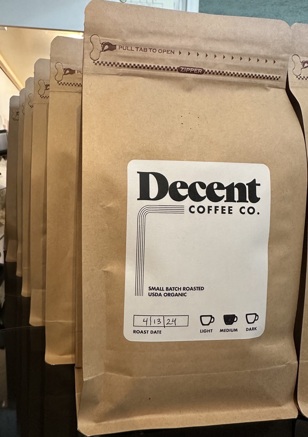 Printed photo of a batch of Decent Coffee bags on the shelf