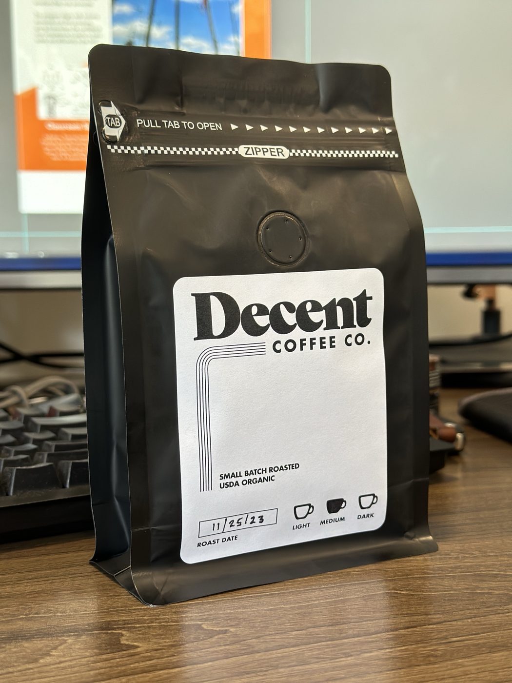 Printed photo of hand-dated Decent Coffee bags