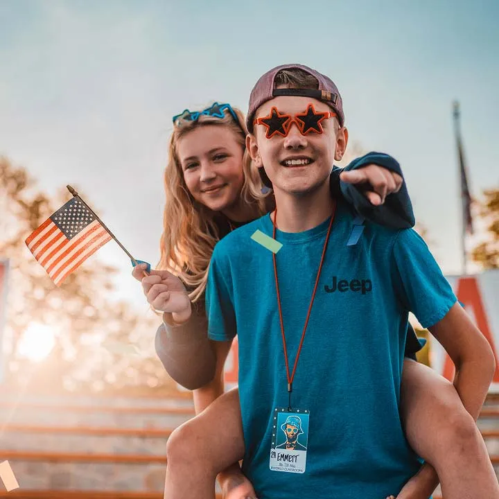 boy and girl waving american flag