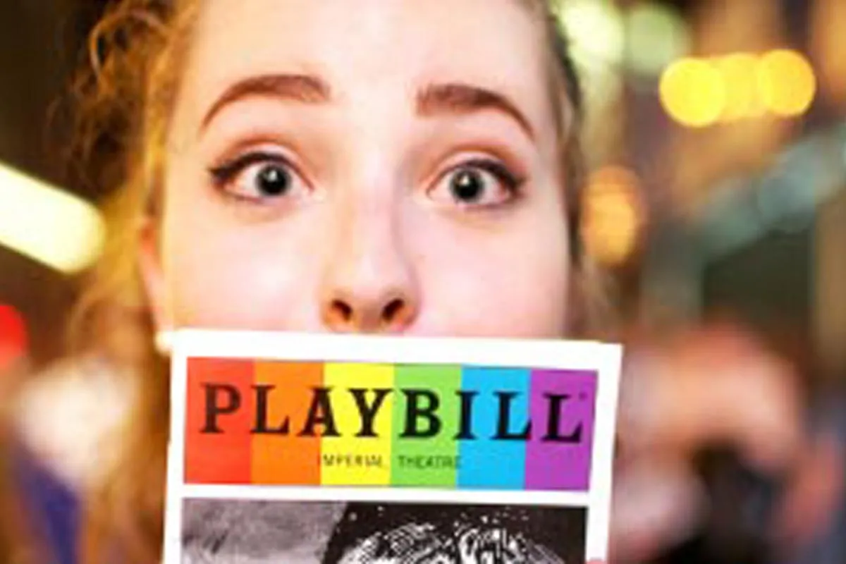 girl holding playbill