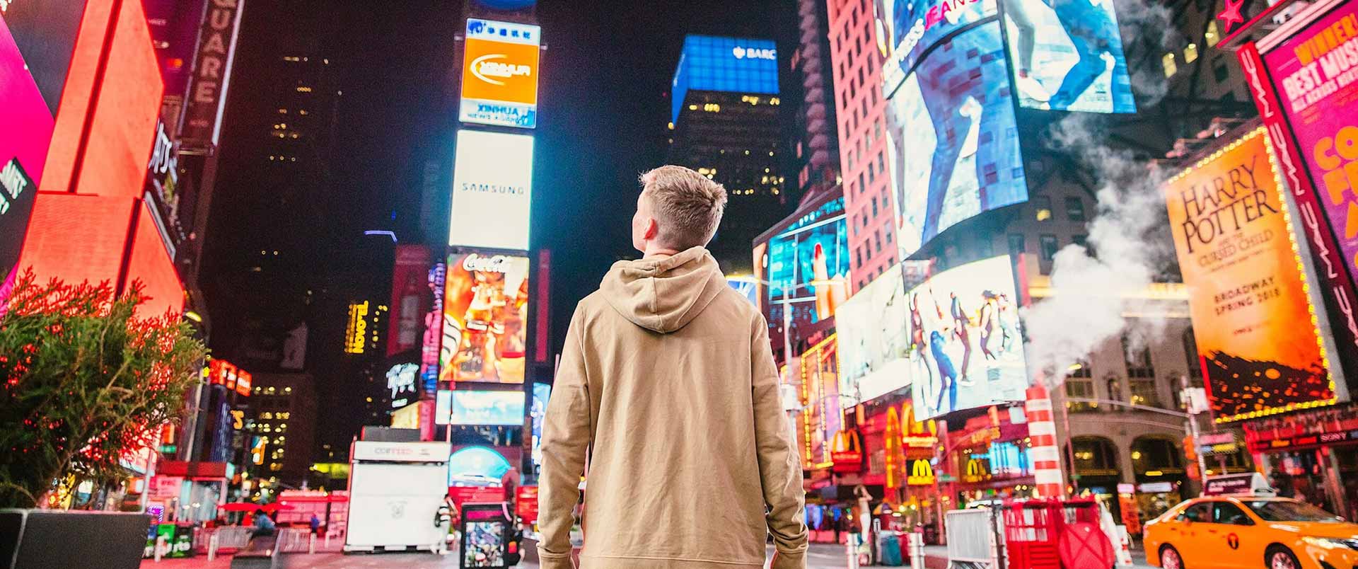 young man in times square at night