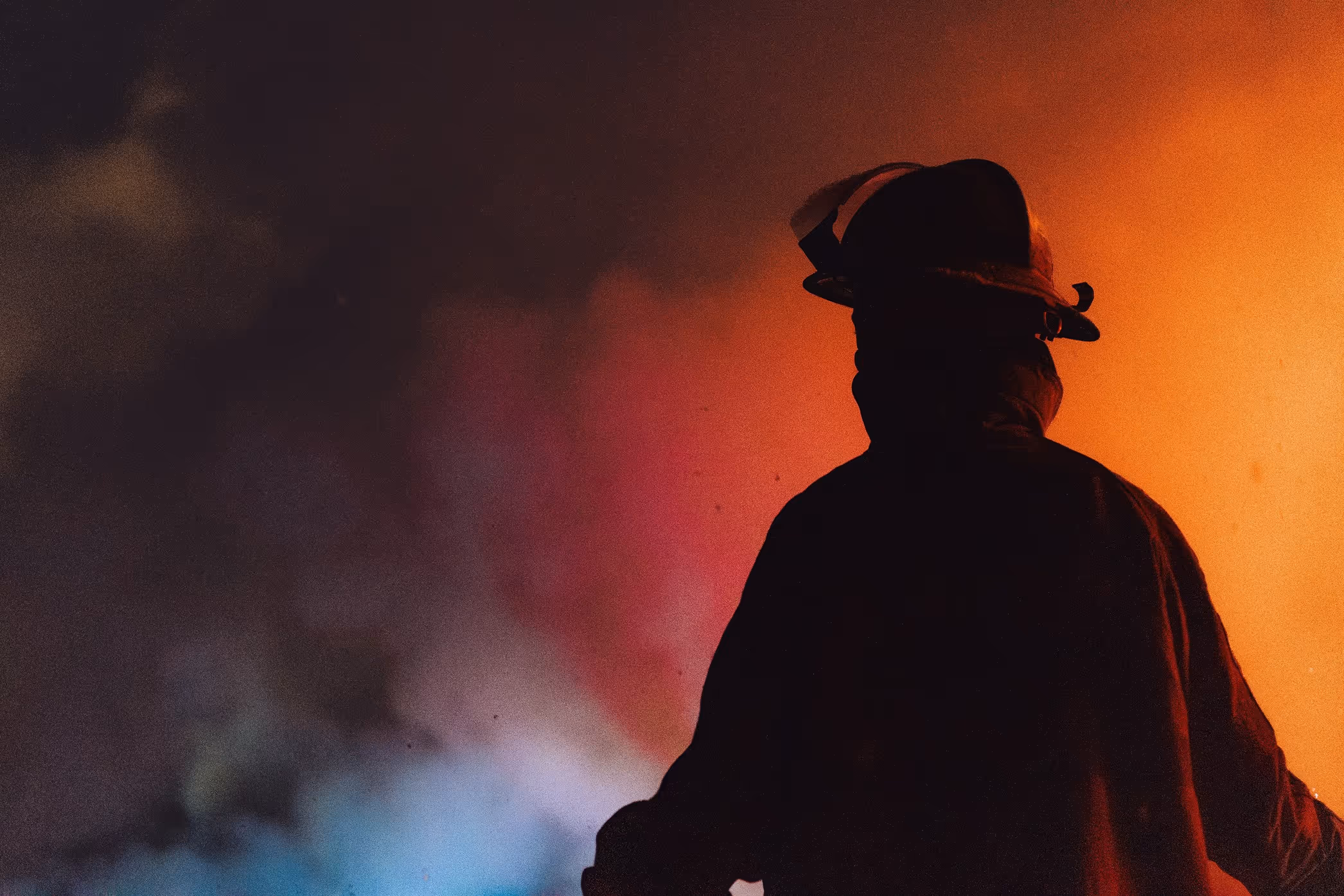 Firefighter standing in smoke