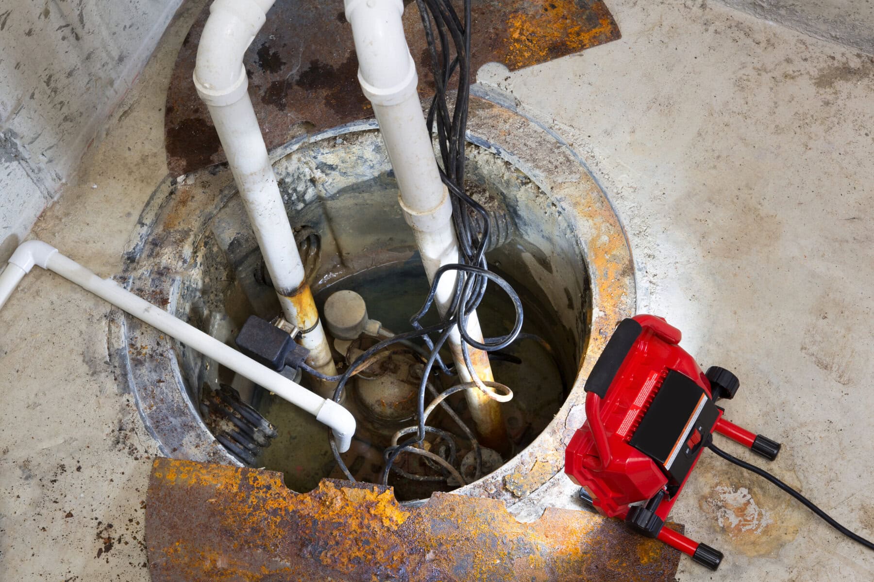 Basement sump pump installation with drainage pipes and pump system in Texas