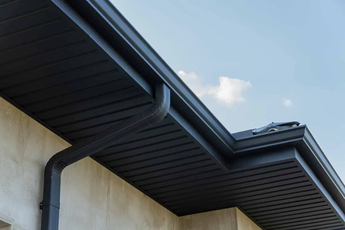 Downspout and gutter drainage system installed to carry roof runoff away from a home