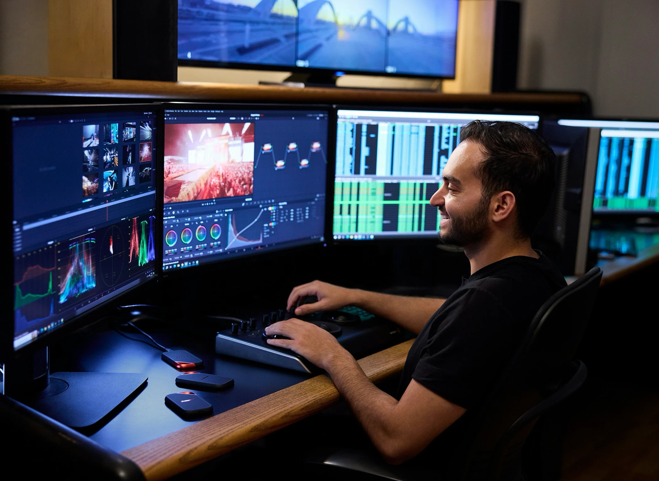 Specialist working across multiple monitors displaying data