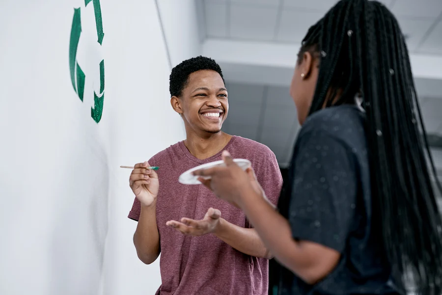 volunteers smiling while working recycling program