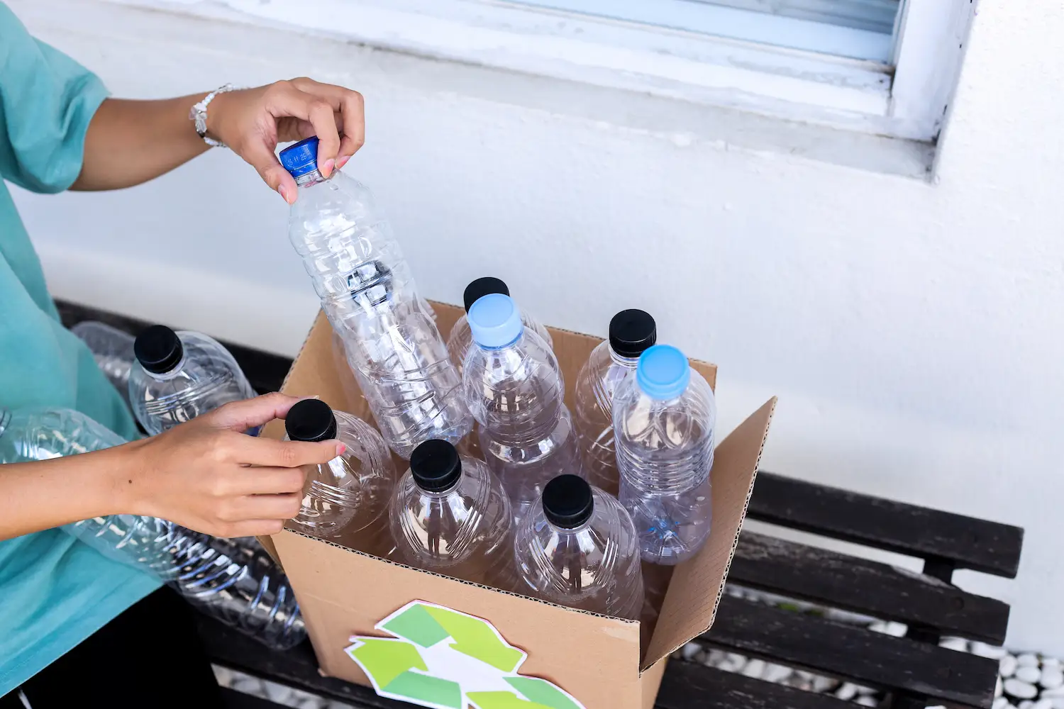 top view hand holding plastic bottles