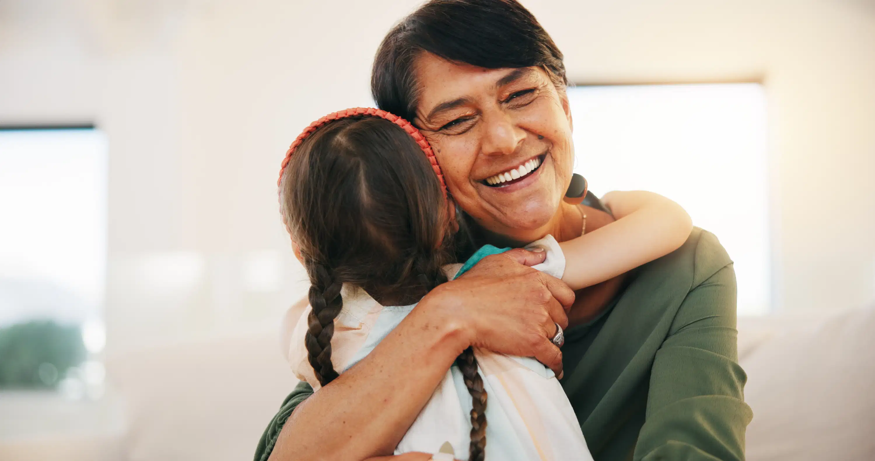 child and grandmother hugging and smiling