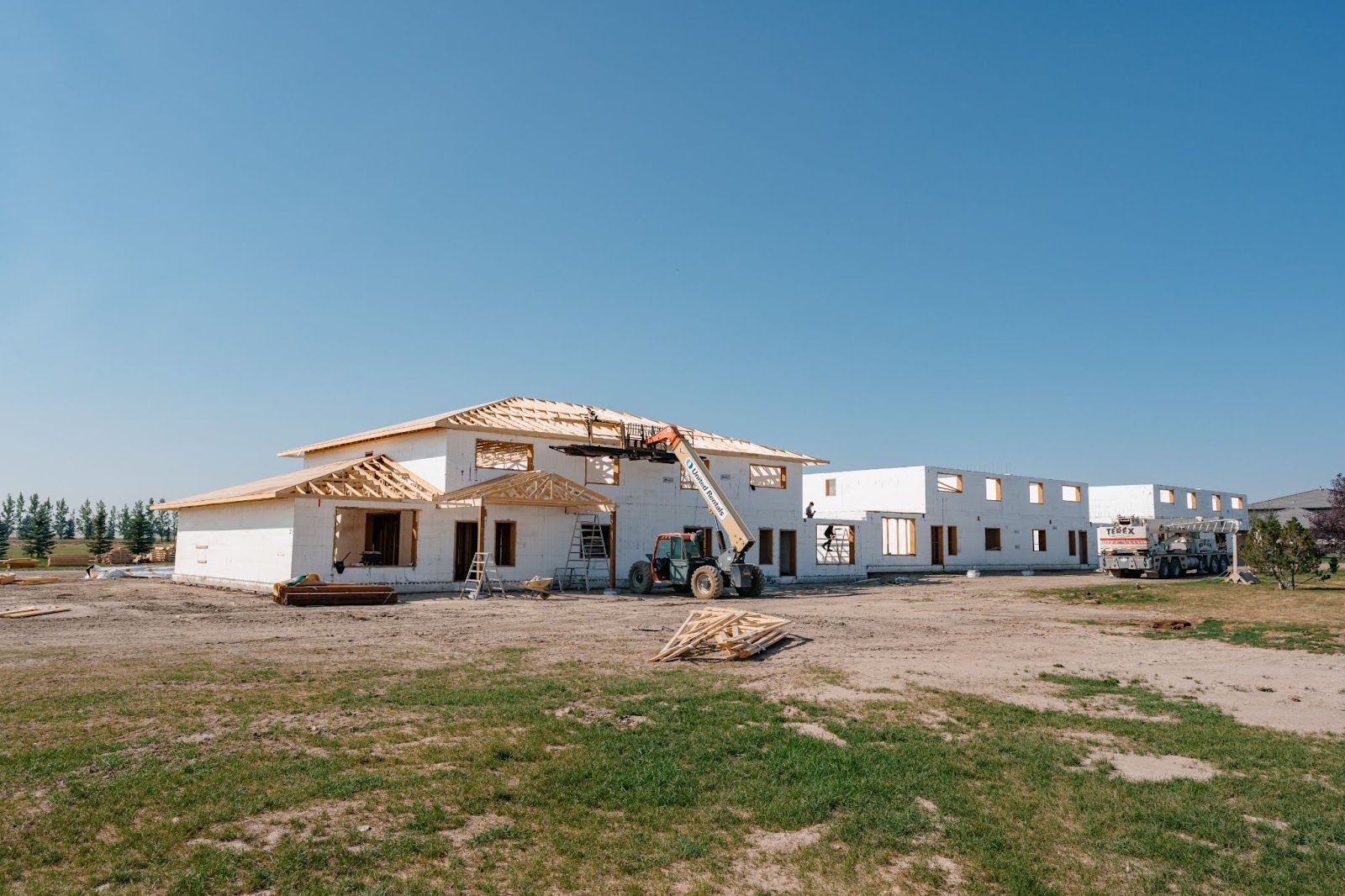 A two-story ICF home is being constructed on a job site.