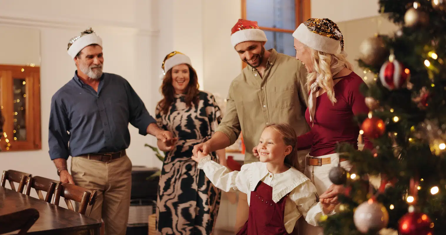 family dancing in living room during holidays