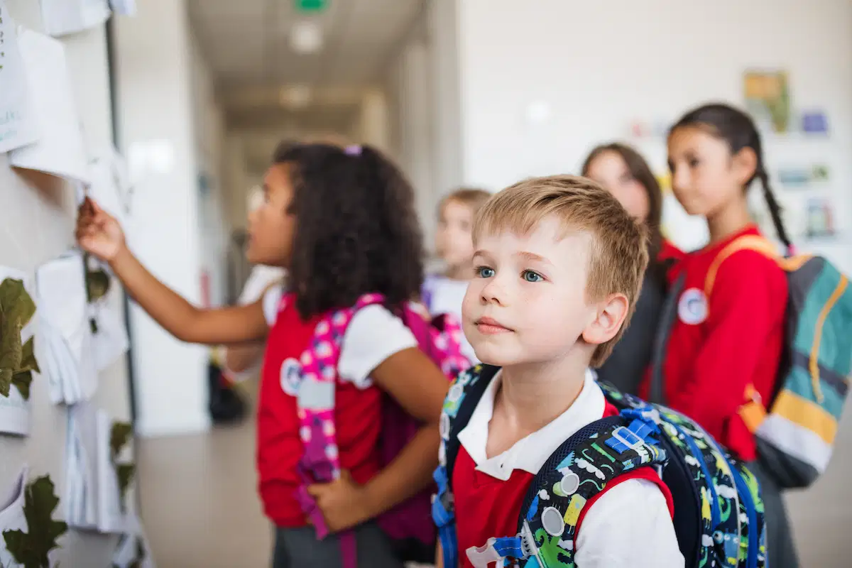 group of cheerful children in school halls