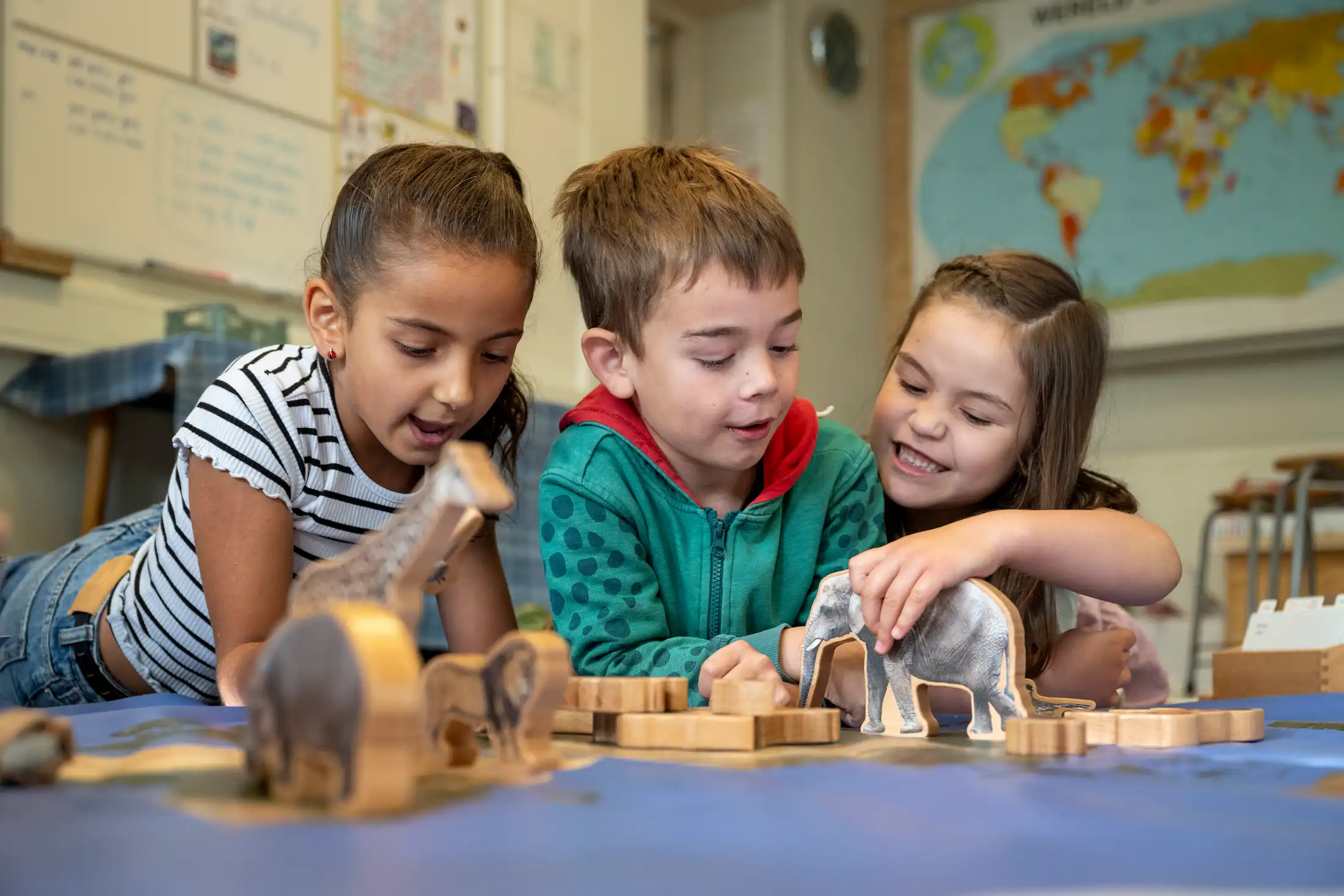 children playing with building blocks together and smiling