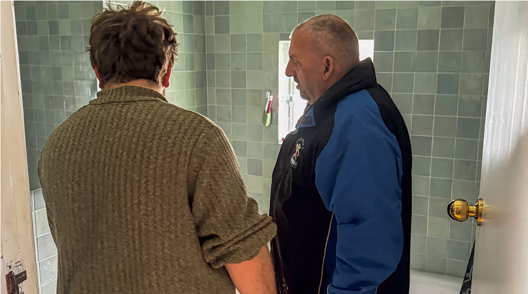 Mick talking to client about a plumbing repair job