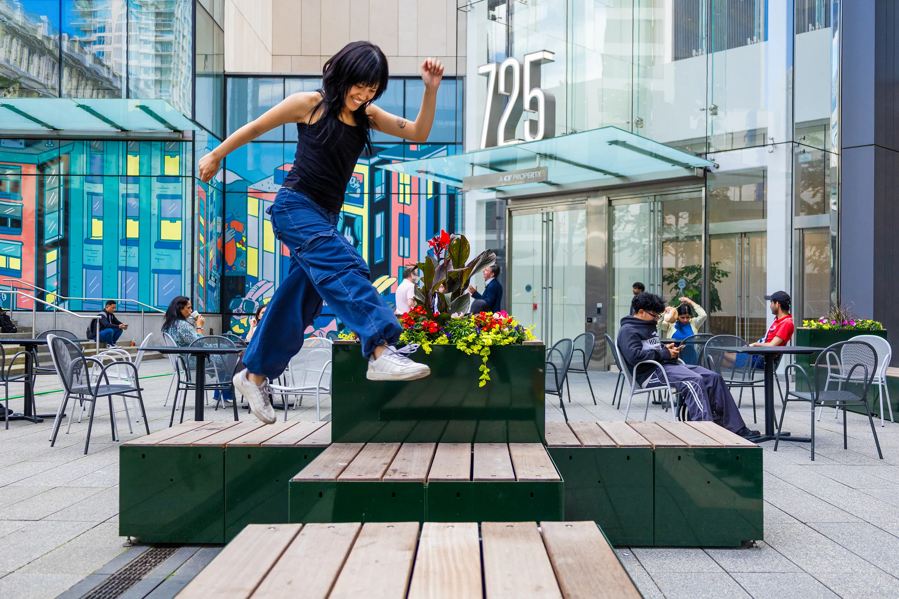 A girl jumping over street furniture