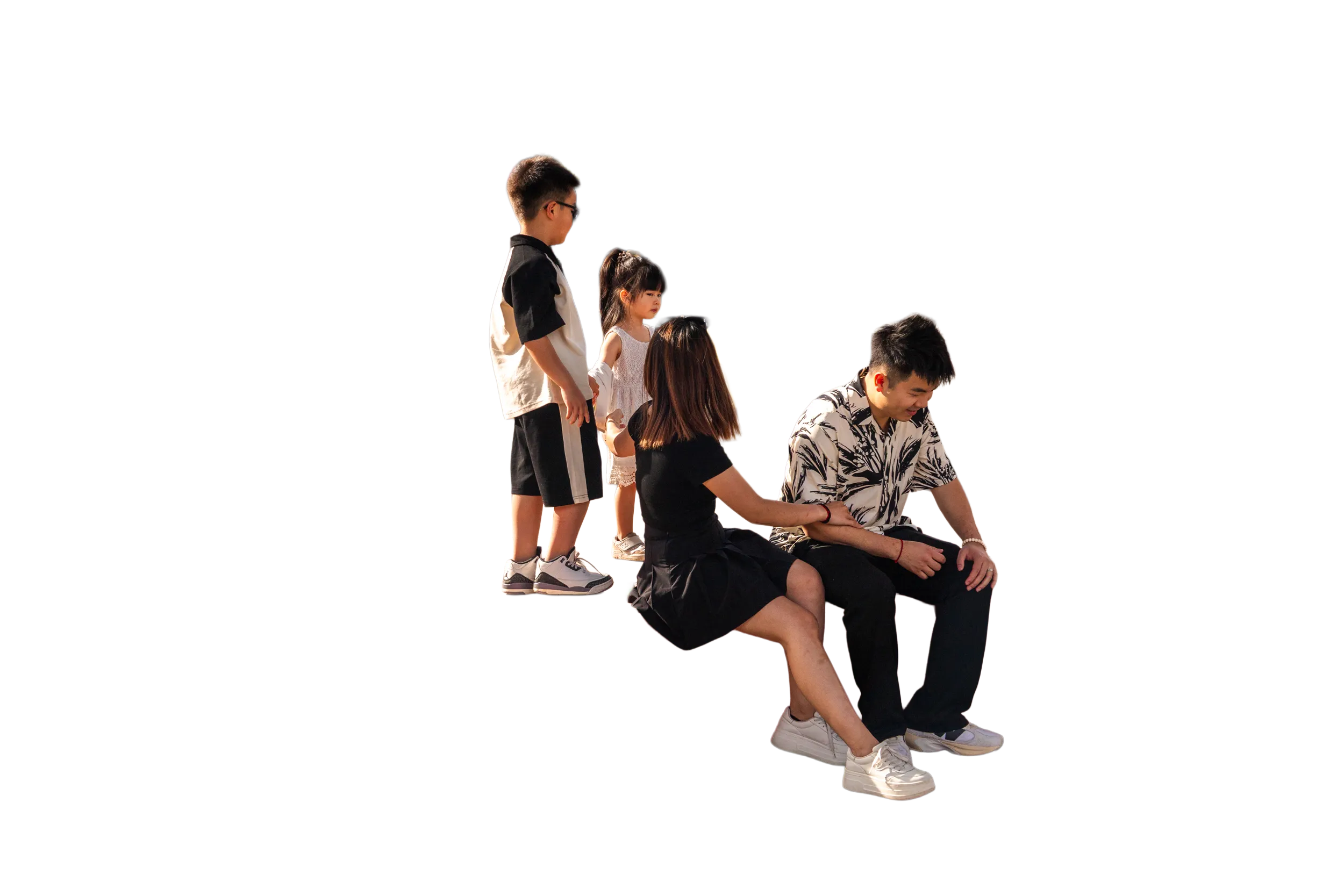 A family sitting on a large, heart-shaped bench