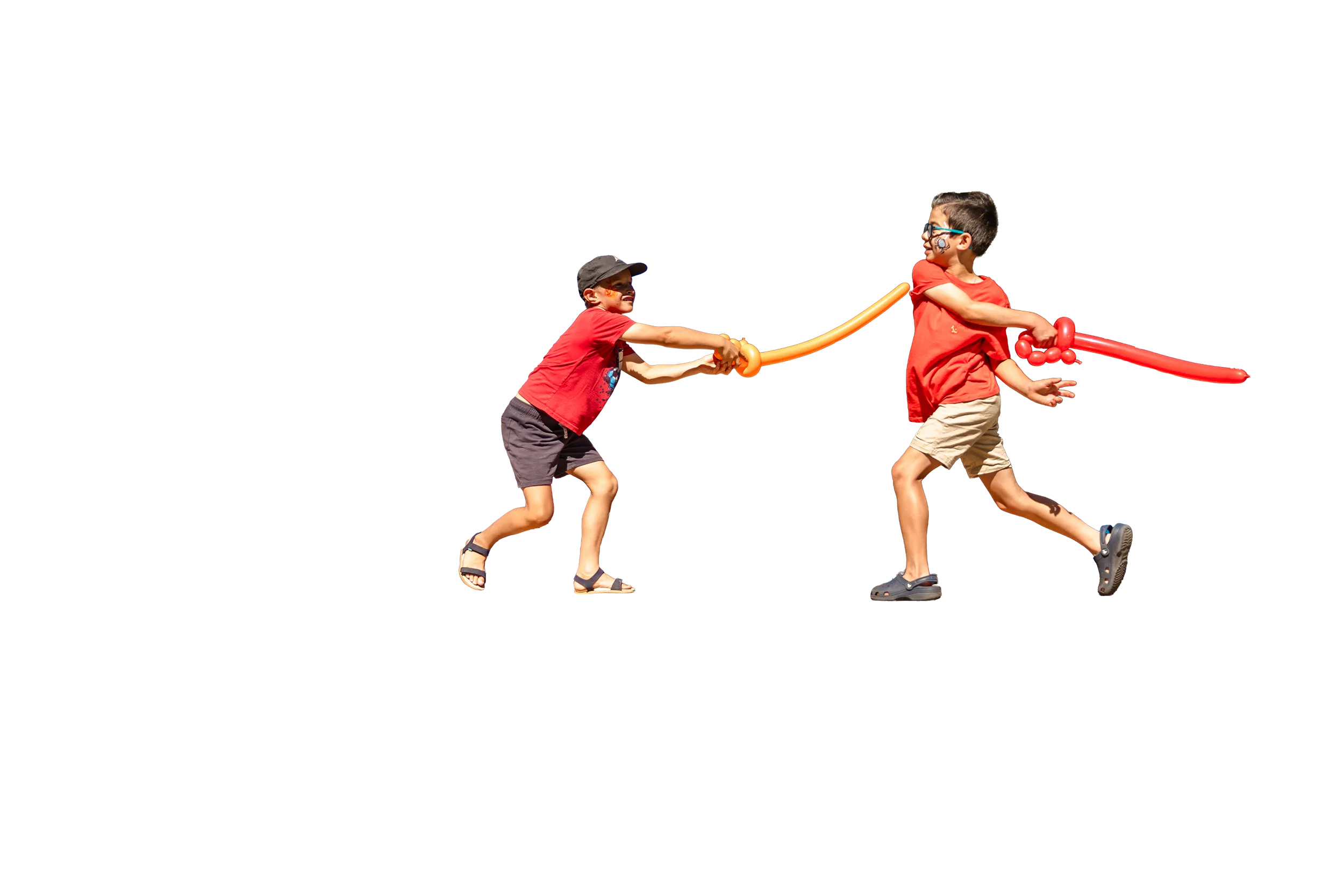 Two kids duelling with balloon swords on top of a large, heart-shaped bench
