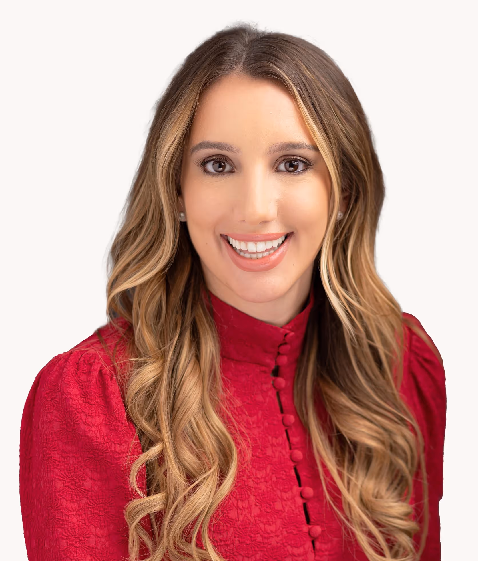 Woman in red blouse with wavy hair smiling brightly at camera