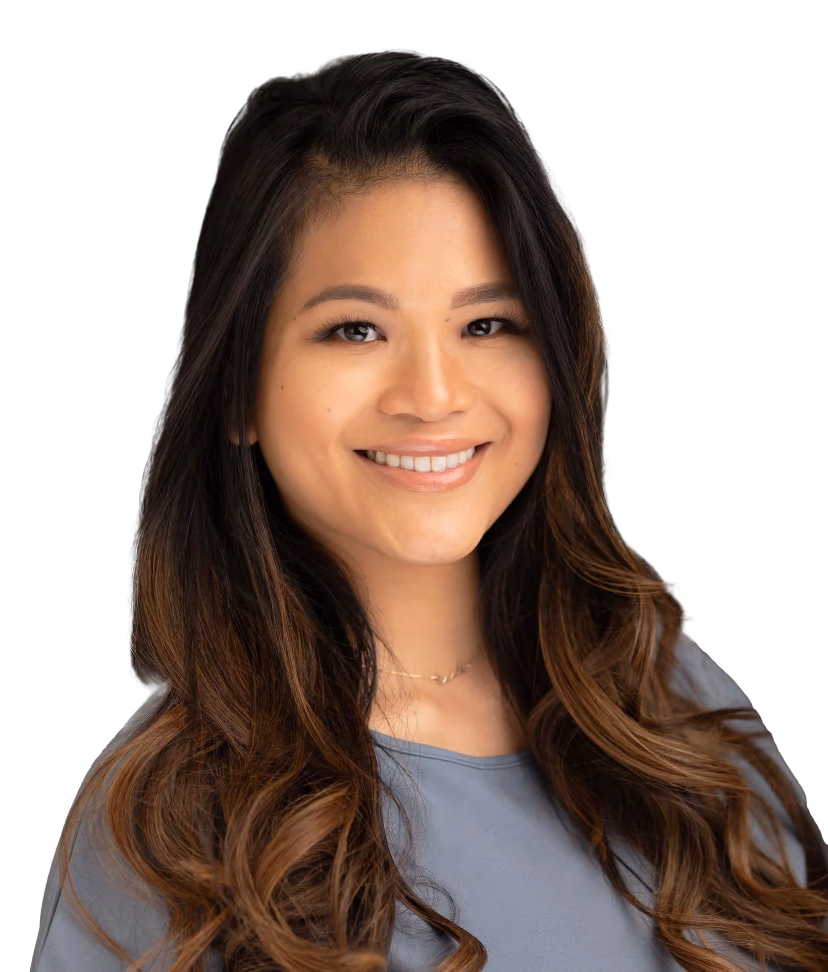 Smiling woman with long wavy hair in gray shirt on white background