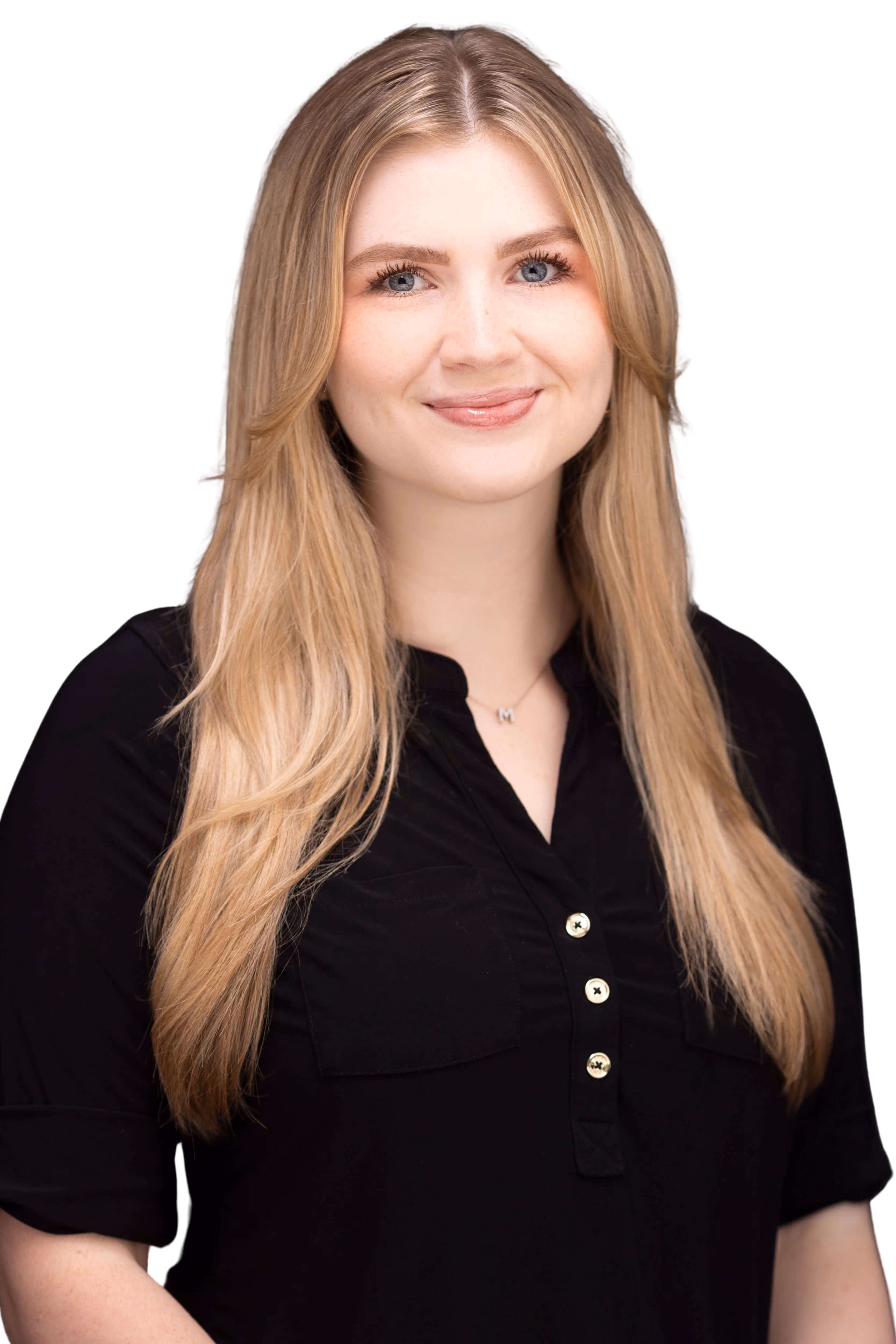 A woman with long blonde hair smiles in a black buttoned shirt