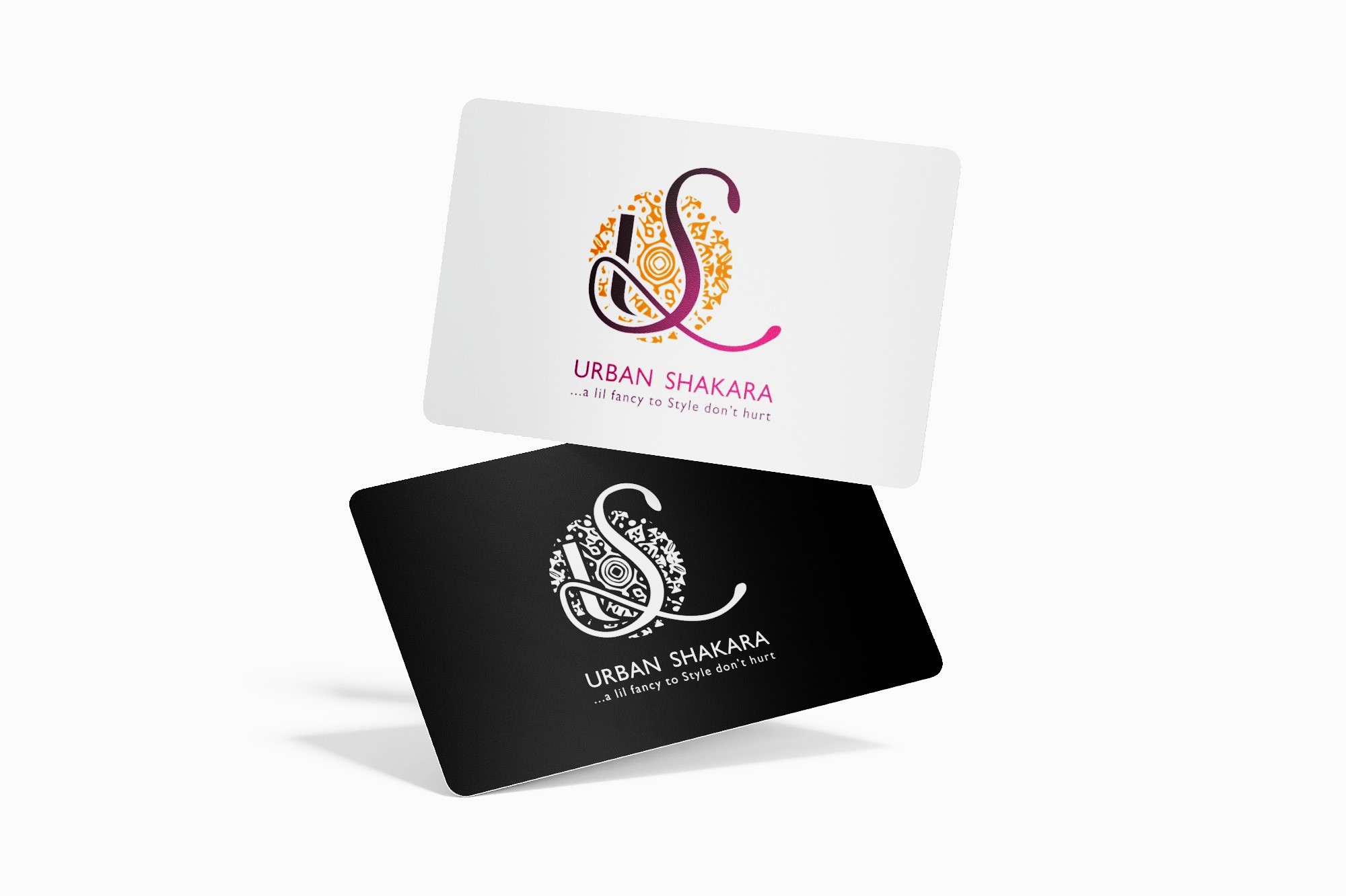 Two business cards for Urban Shakara, one white with colorful logo and text, one black with white logo and text, both showing tagline '...a lil fancy to Style don't hurt'.