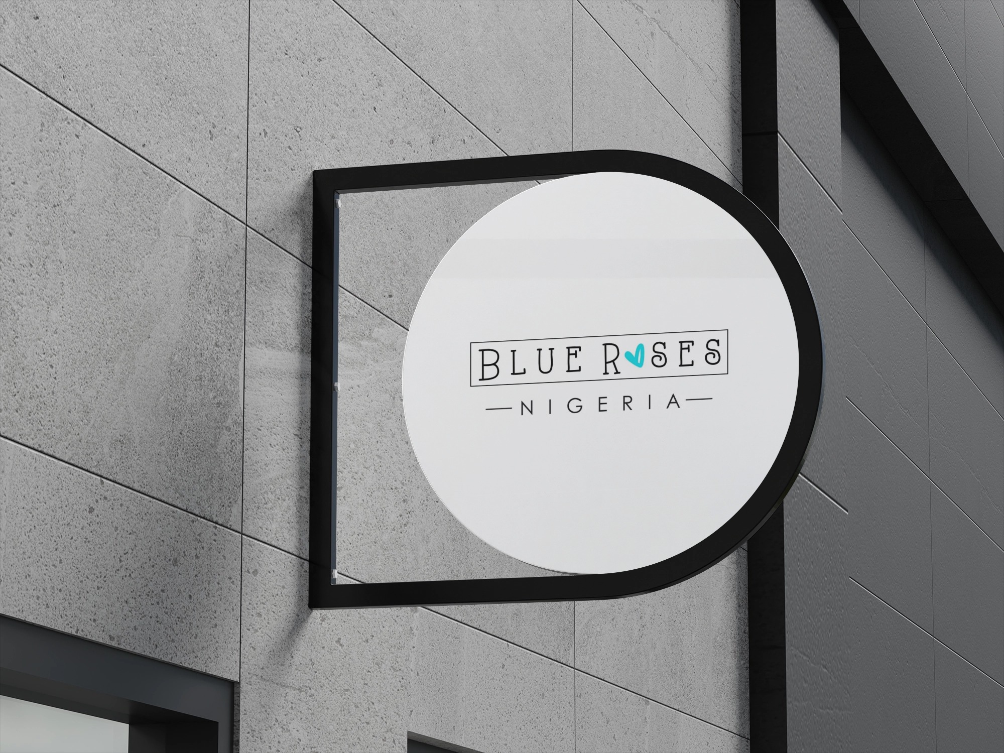 Round black-framed sign on a gray building wall with text 'BLUE ROSES NIGERIA' and a small blue heart over the letter O.
