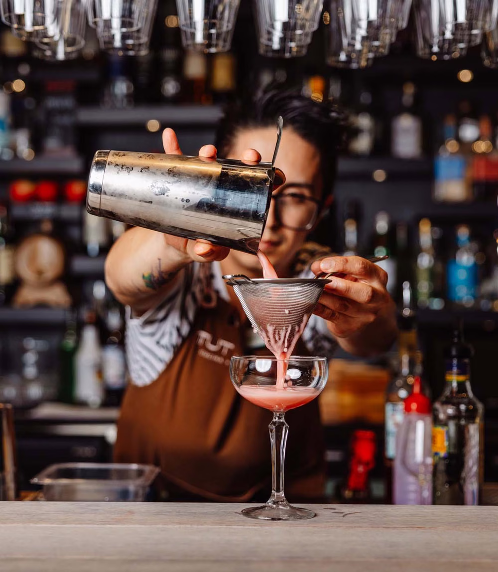 Bartender crafting a cocktail at Tutto Cucina + Bar, Adelaide