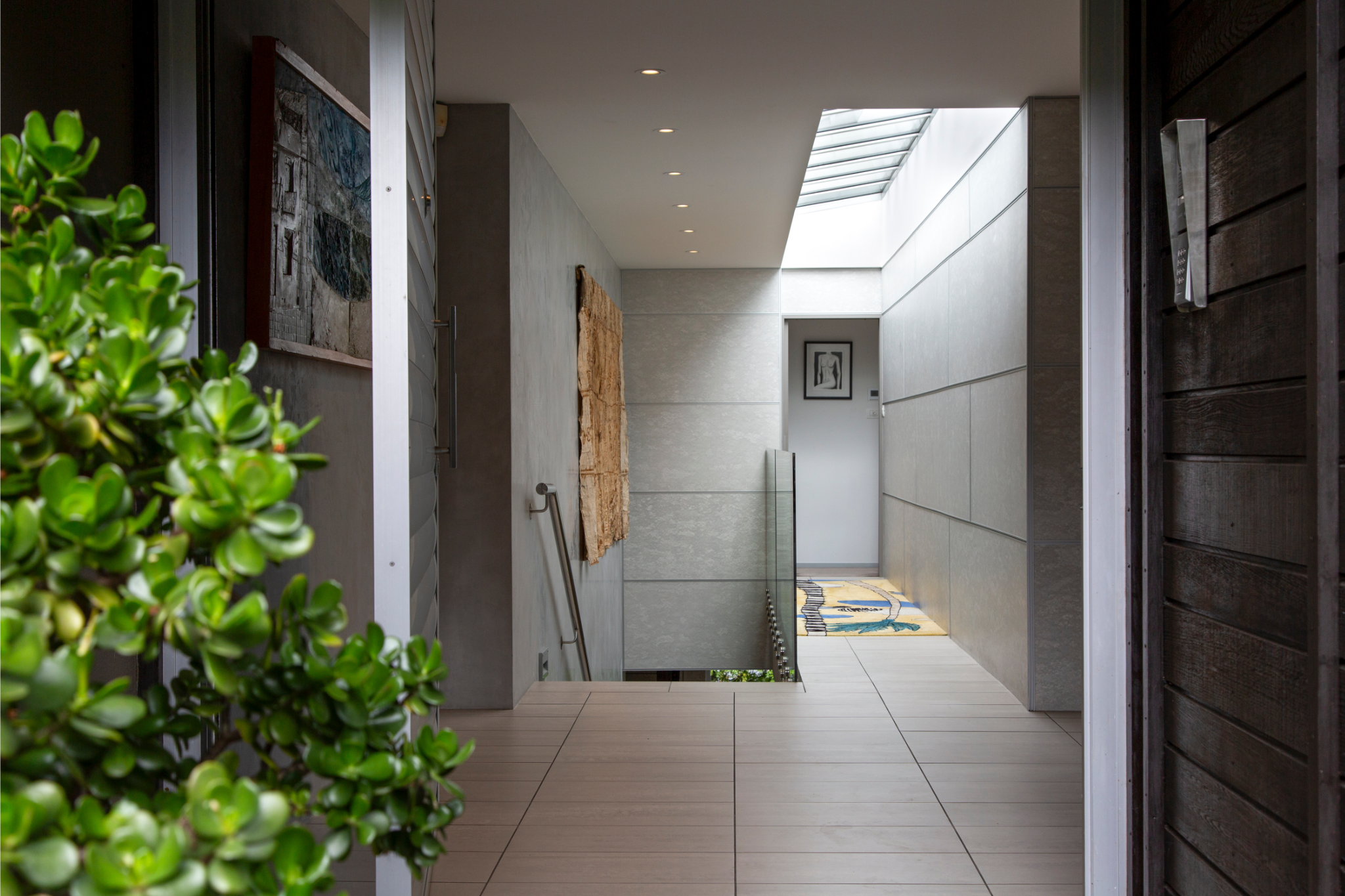 Private outdoor deck with seating area overlooking native New Zealand bush, perfect for relaxing at an Auckland short-term rental.