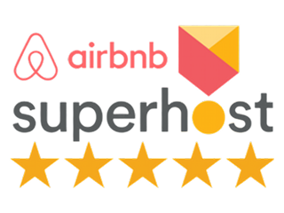 Airbnb Superhost badge with Airbnb logo in red and orange-yellow medal graphic.