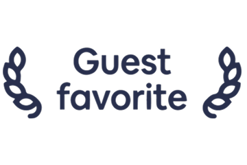 Text reading 'Guest favorite' decorated with two symmetrical leaf designs on each side.