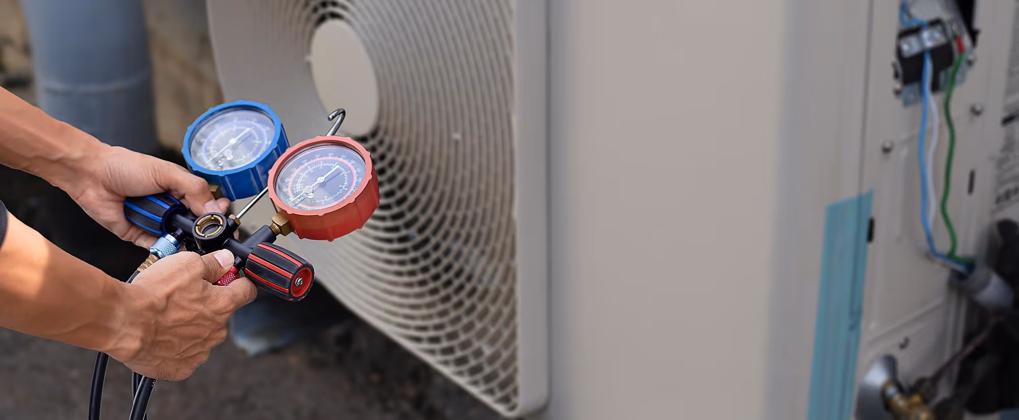 A man is working on an air conditioner.