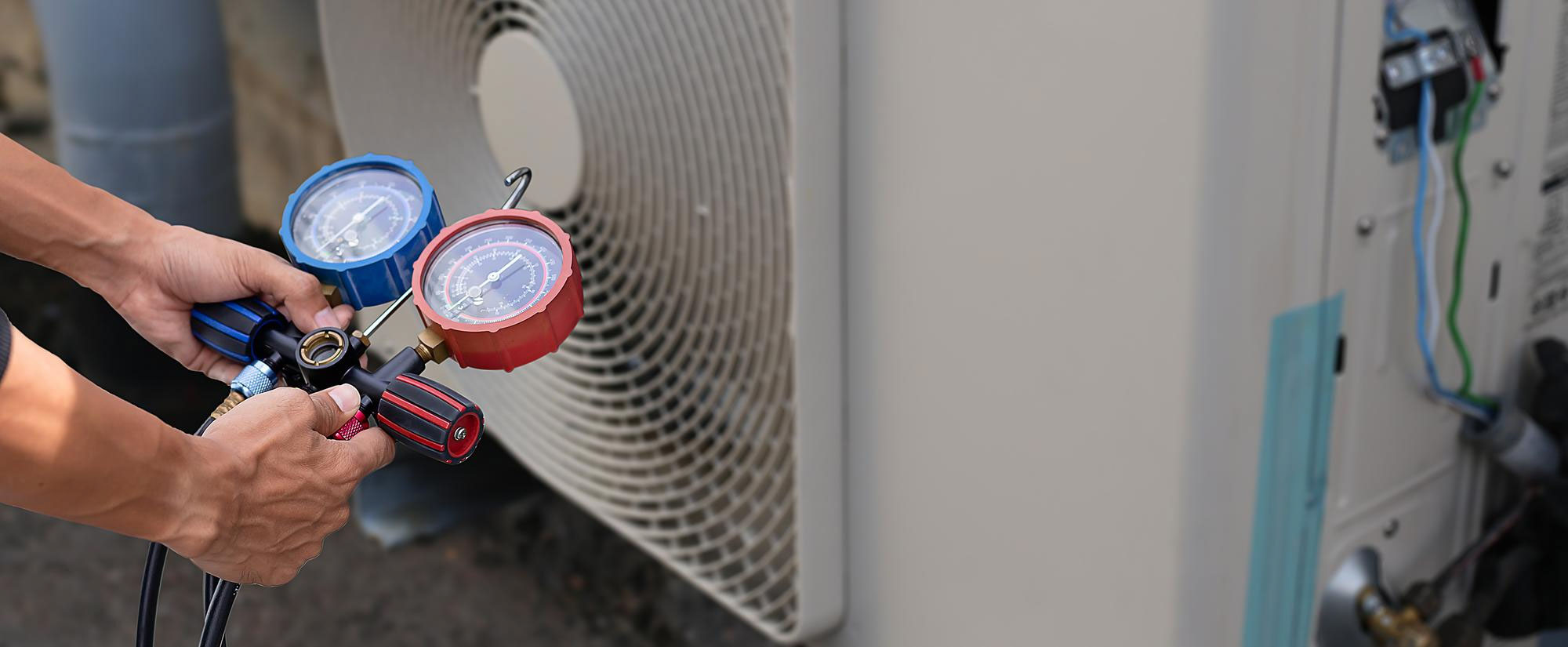 A man is working on an air conditioner.