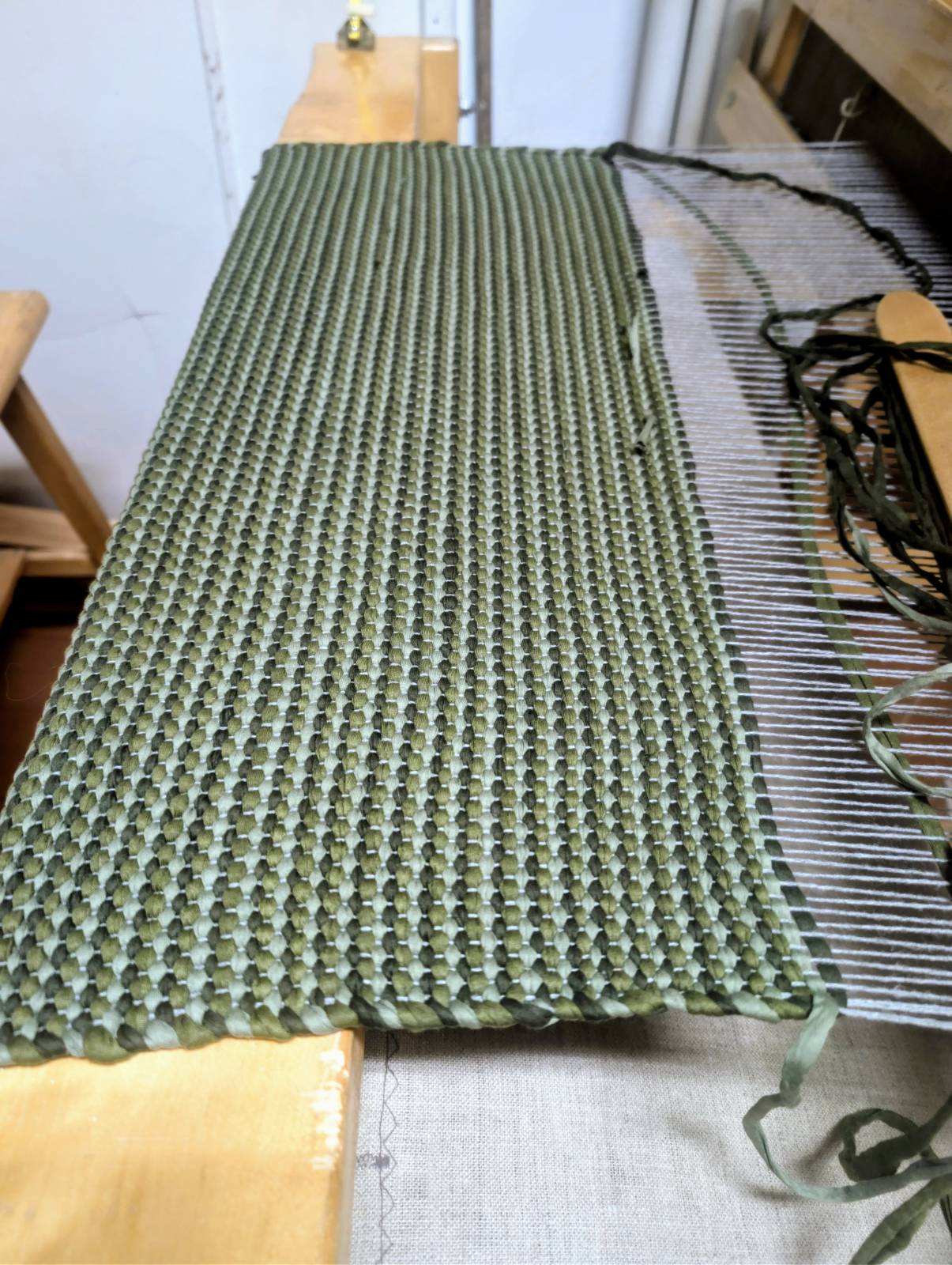 Traditional Finnish räsymatto rug being woven on a wooden loom in Lapland.