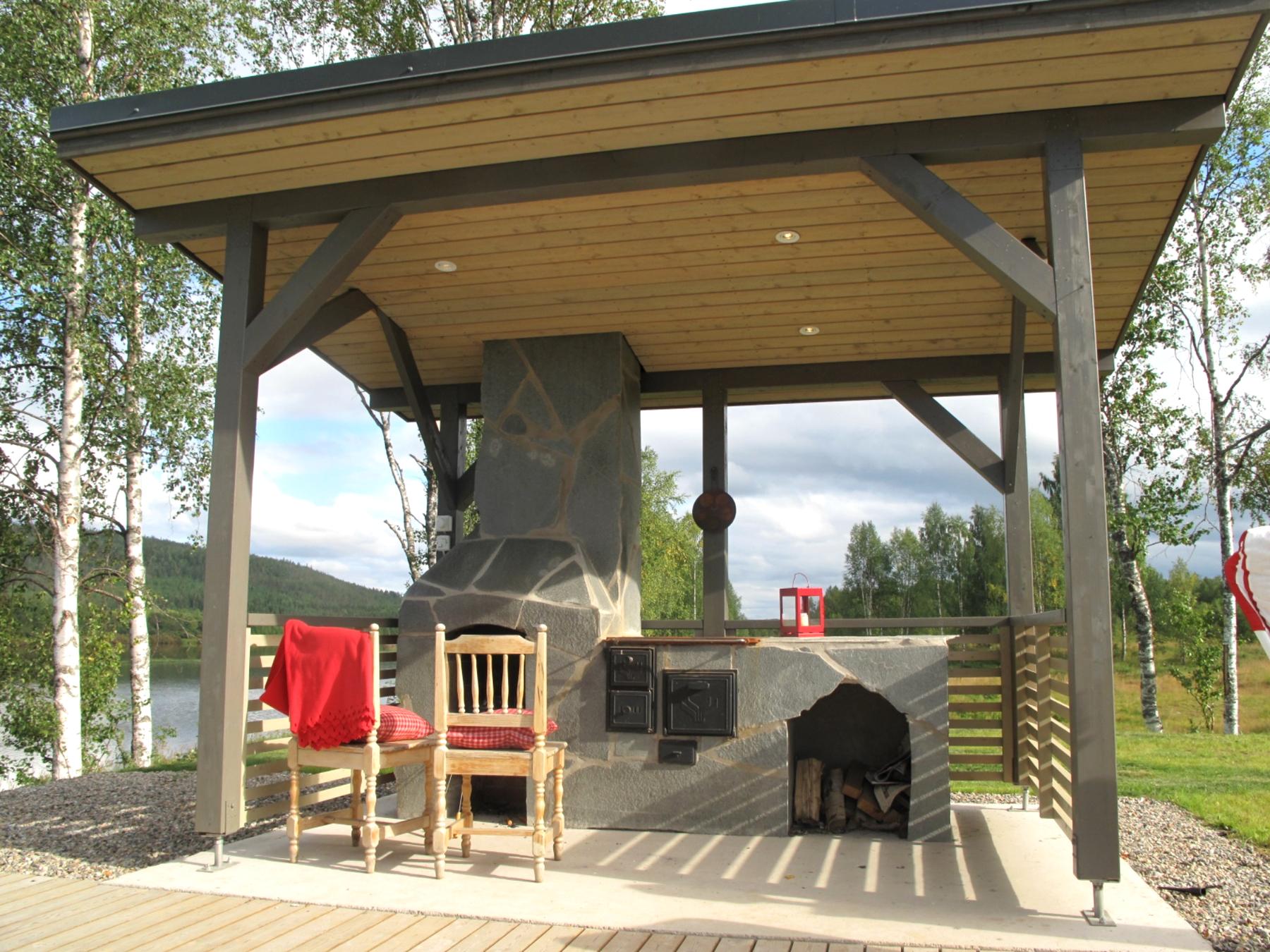 Outdoor BBQ area at sauna cottage by the lake