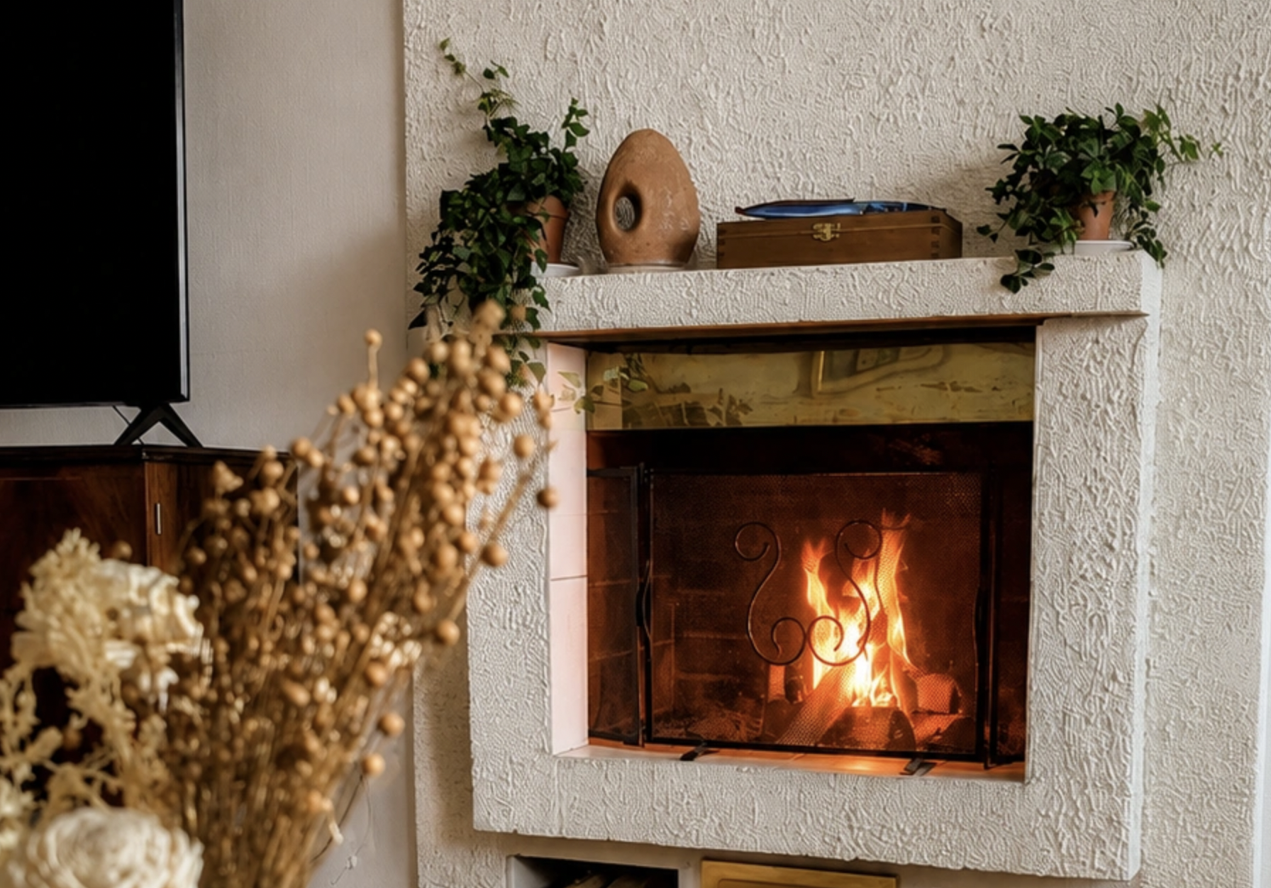 Warm living room with a wood-burning fireplace in a cosy apartment in Rovaniemi, Finnish Lapland.