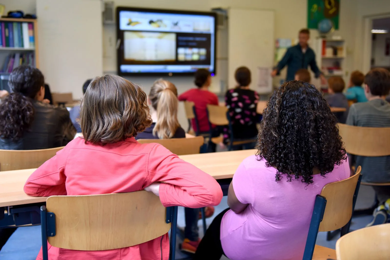 Elementary school students watching a lesson in a classroom