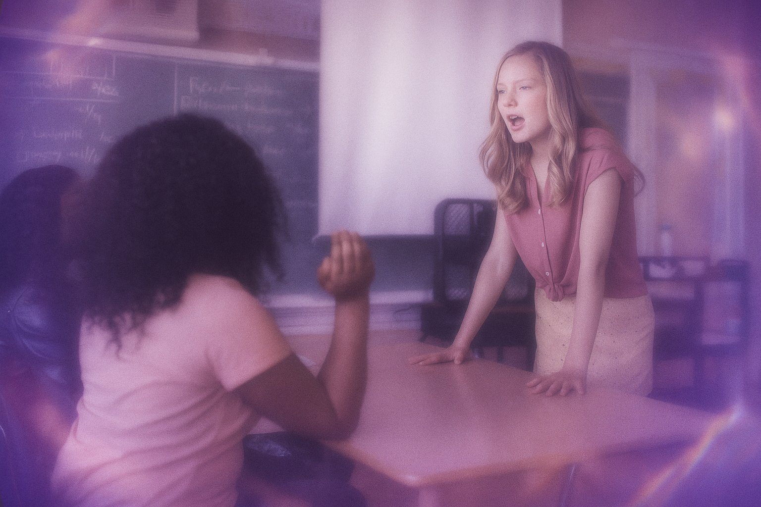 High school students in a classroom discussion with their teacher
