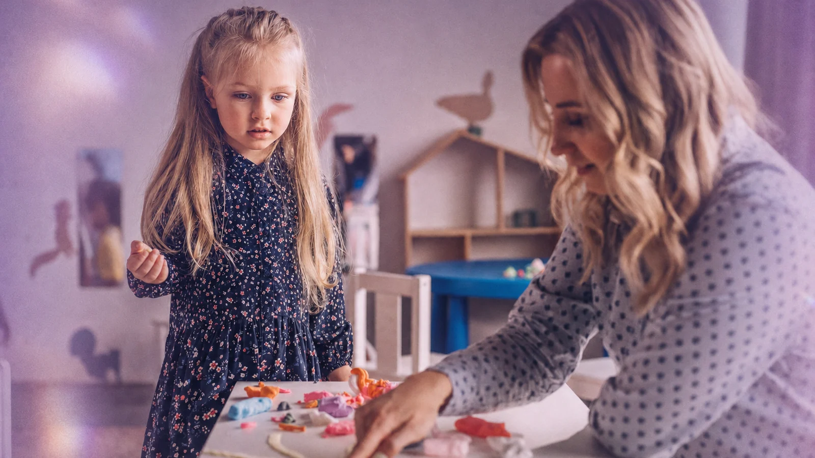 A behavior analyst working one to one with a child at a table
