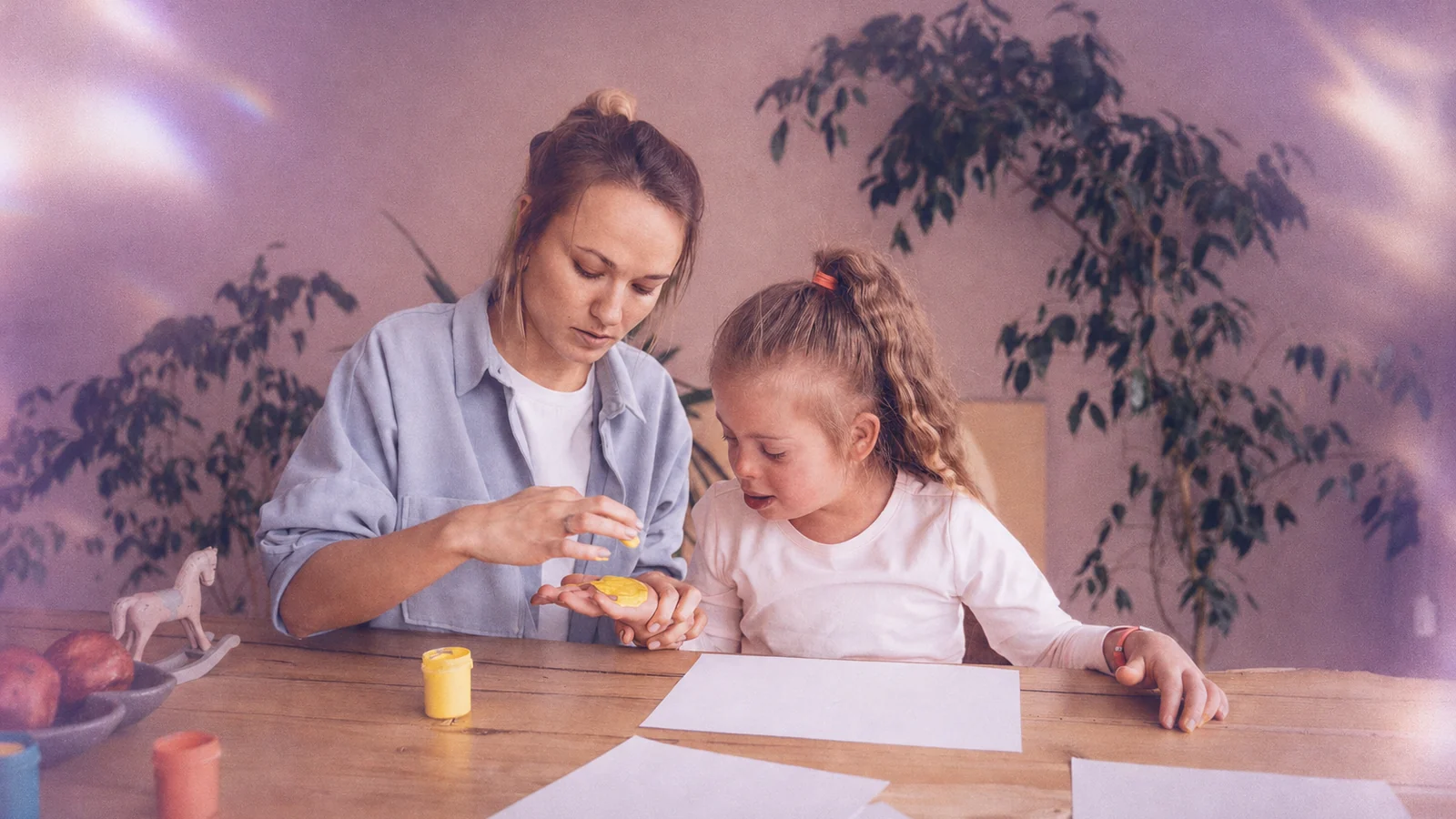 A behavior analyst doing a hands-on activity with a child